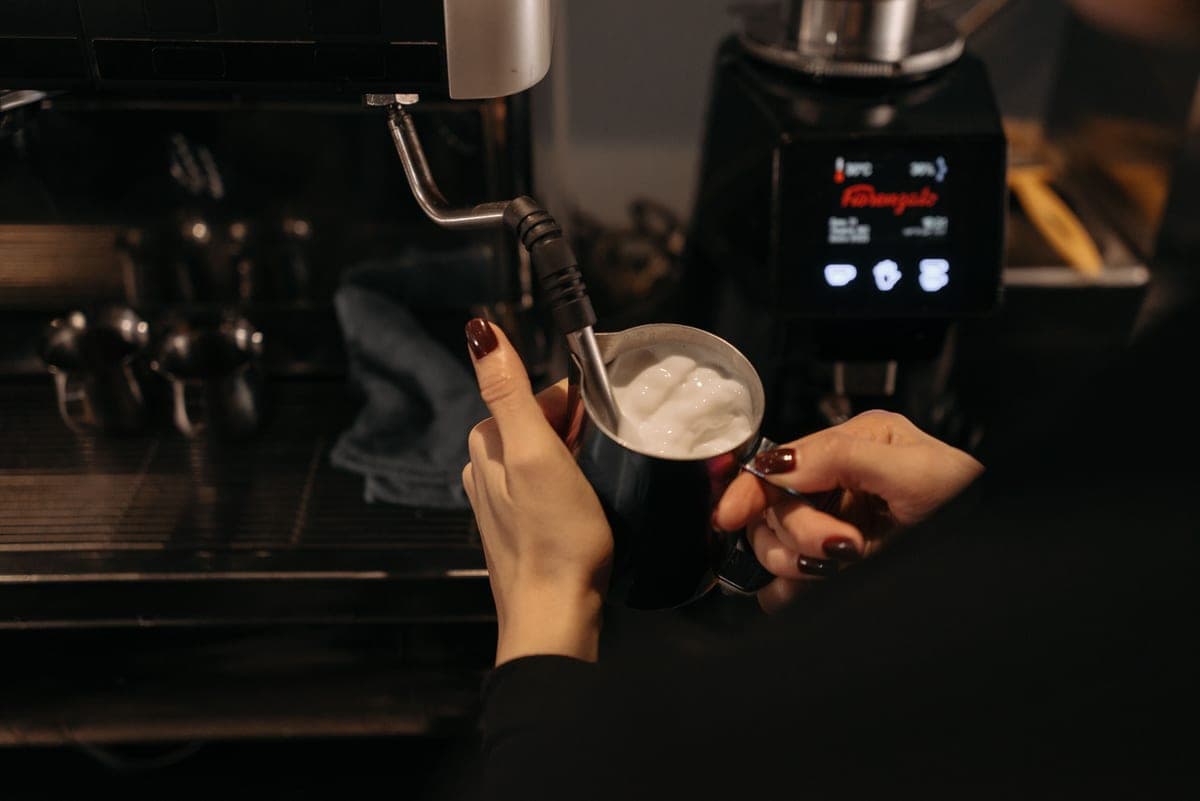 Milk being steamed to microfoam with an espresso machine steam wand